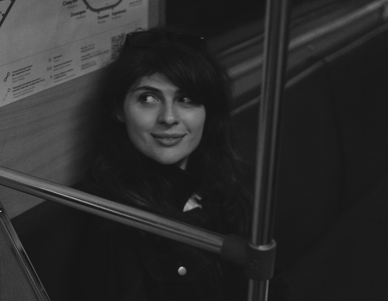 B&W photo of woman seating on the train.