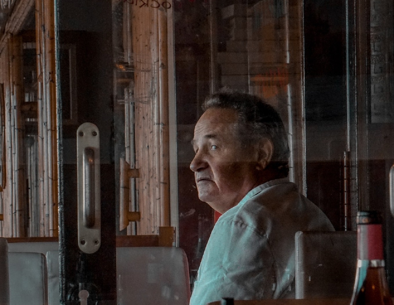 Senior man is seating at restaurant.