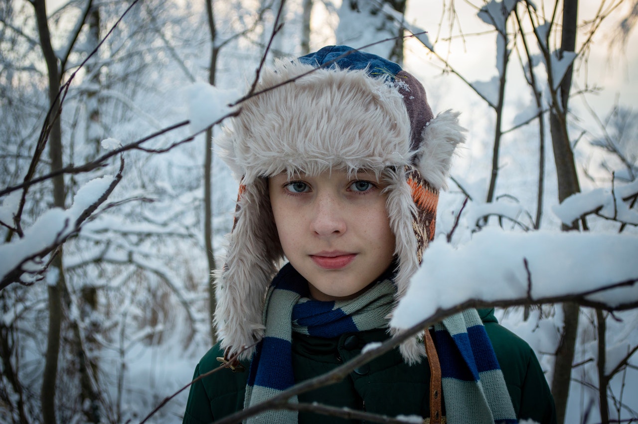Kid in the woods in winter.