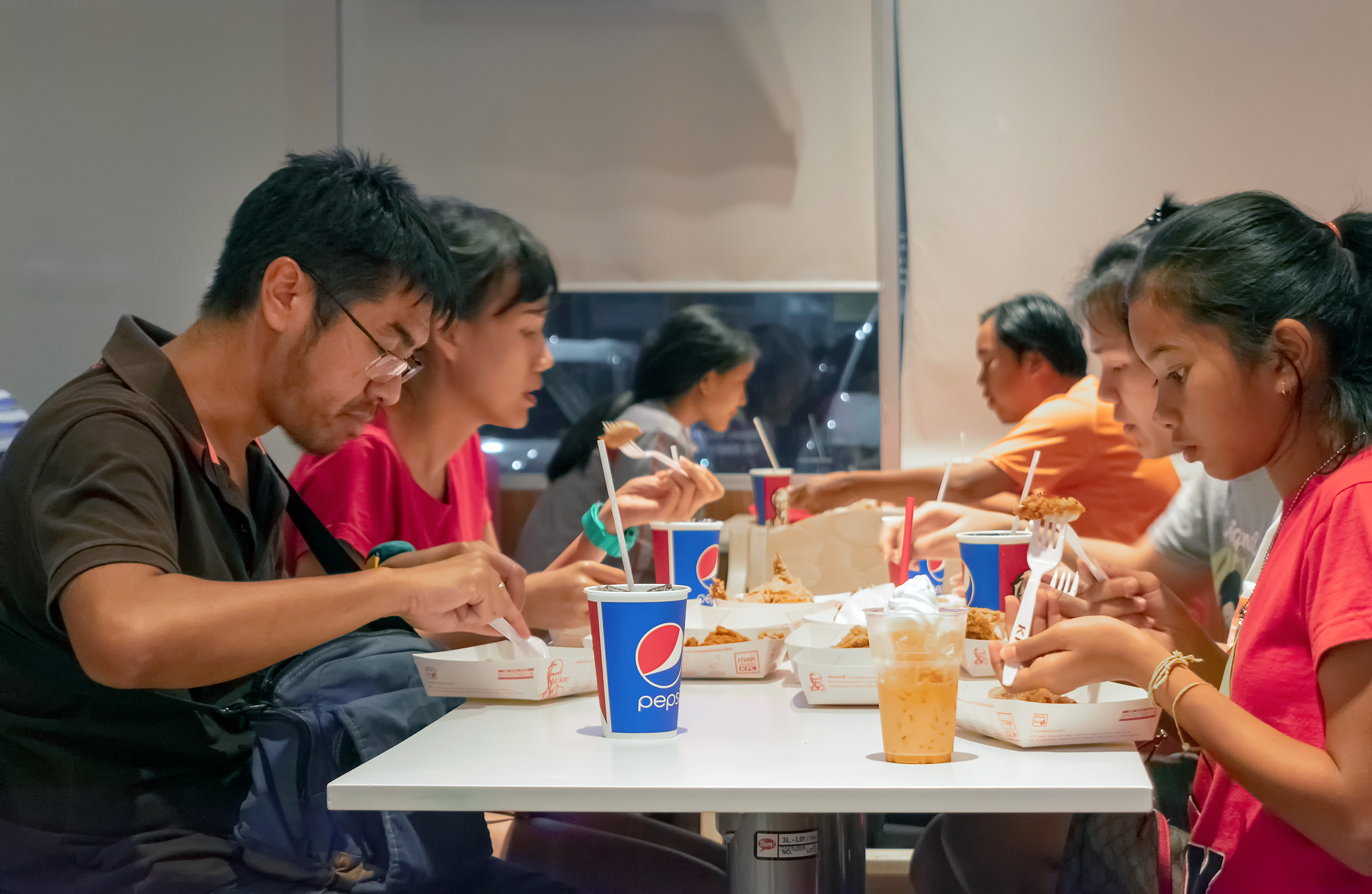 People dinning at fast food restaurant in KFC in Bangkok.
