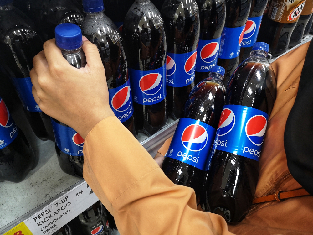 Hand taking and buying a PEPSI