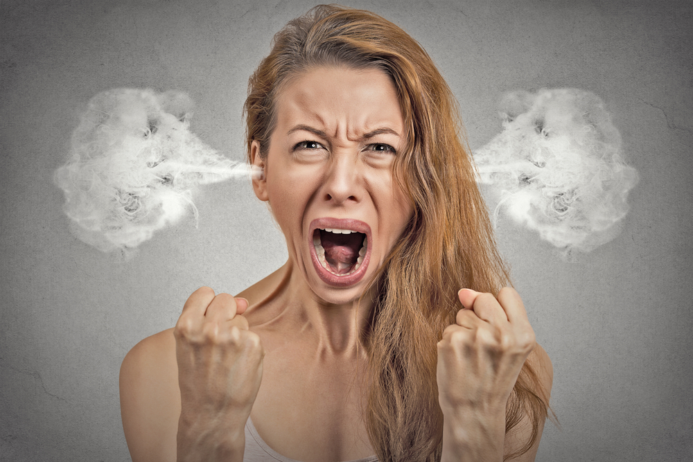 Closeup portrait angry young woman with blowing steam coming out of her ears, having nervous breakdown, screaming