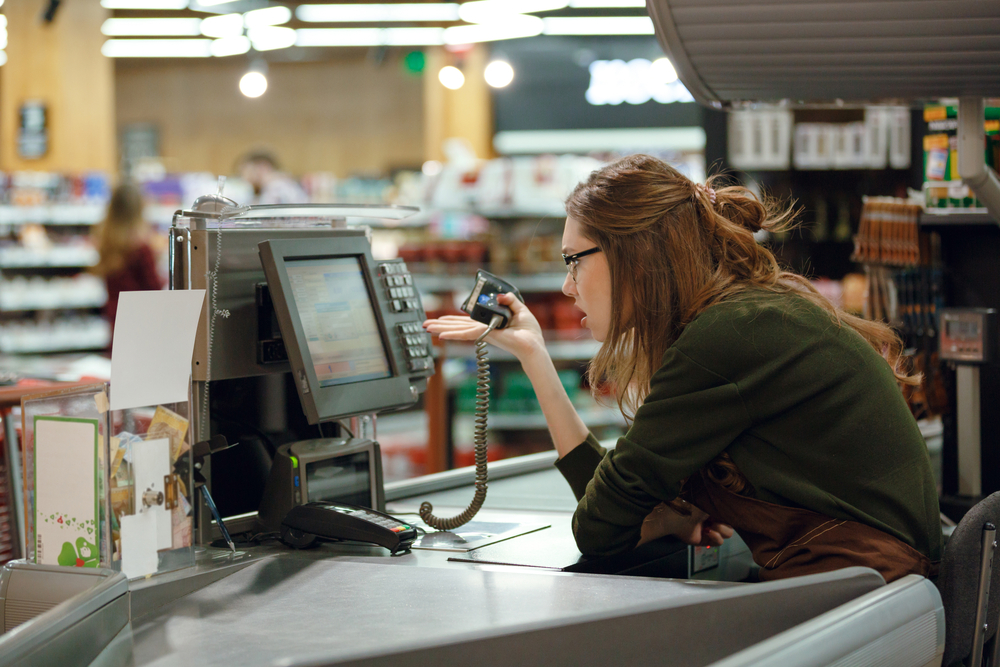 Side view image of confused cashier at work space