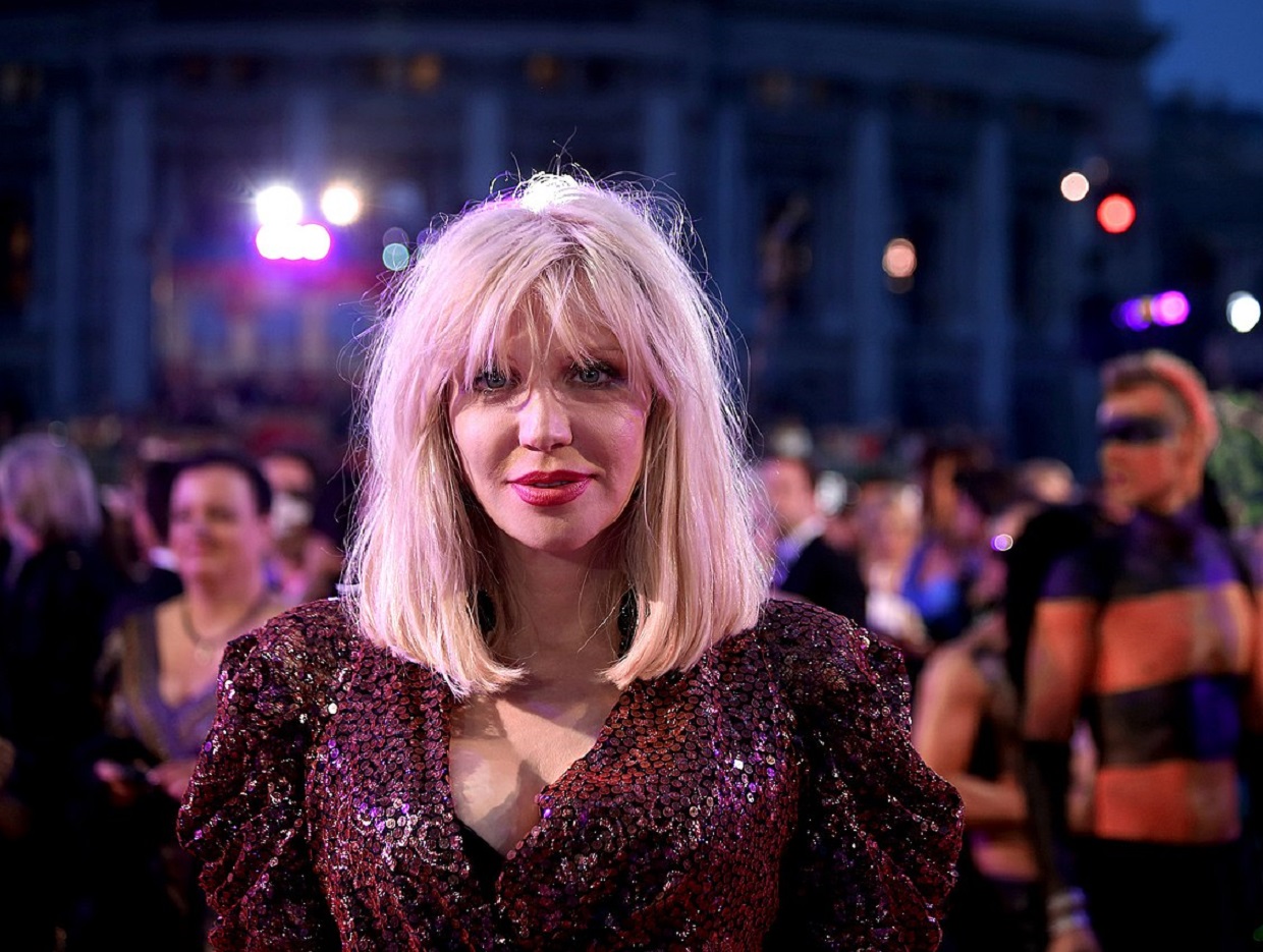 Courtney Love wearing red dress and looking at camera - 2014