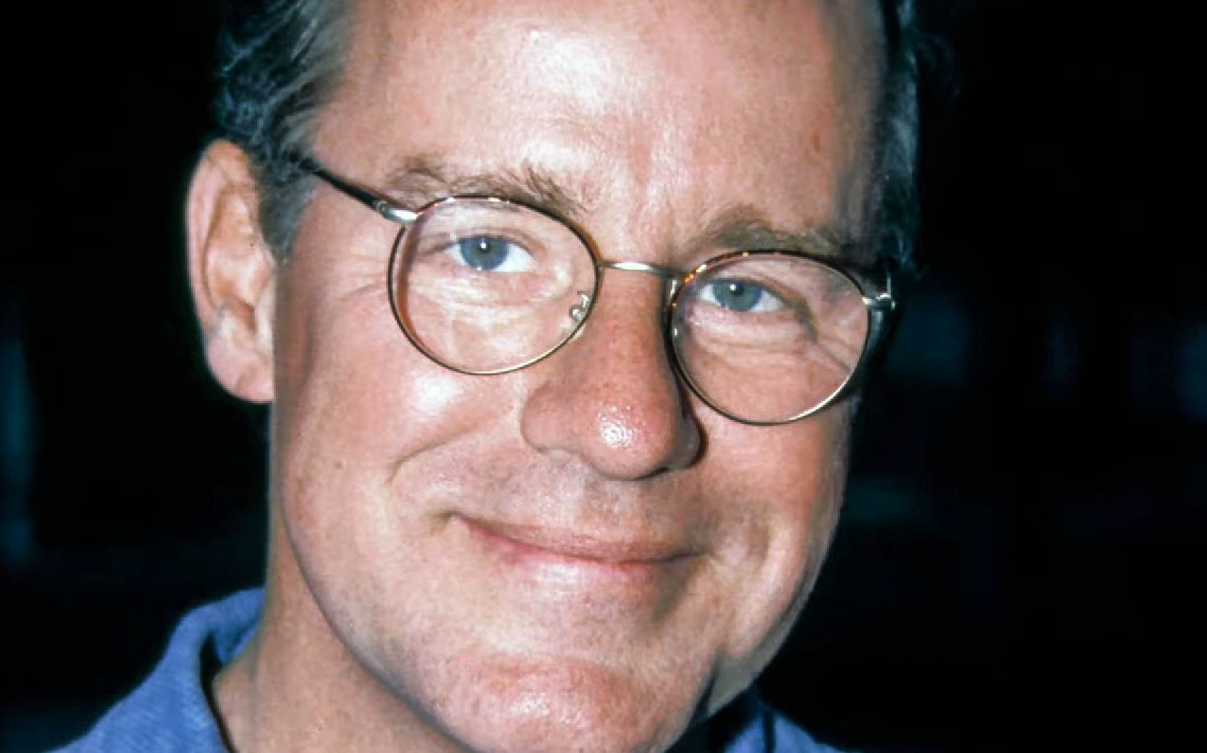 Screenshot: Phil Hartman wearing glasses and looking at camera - from The Last Days of Phil Hartman (2019)