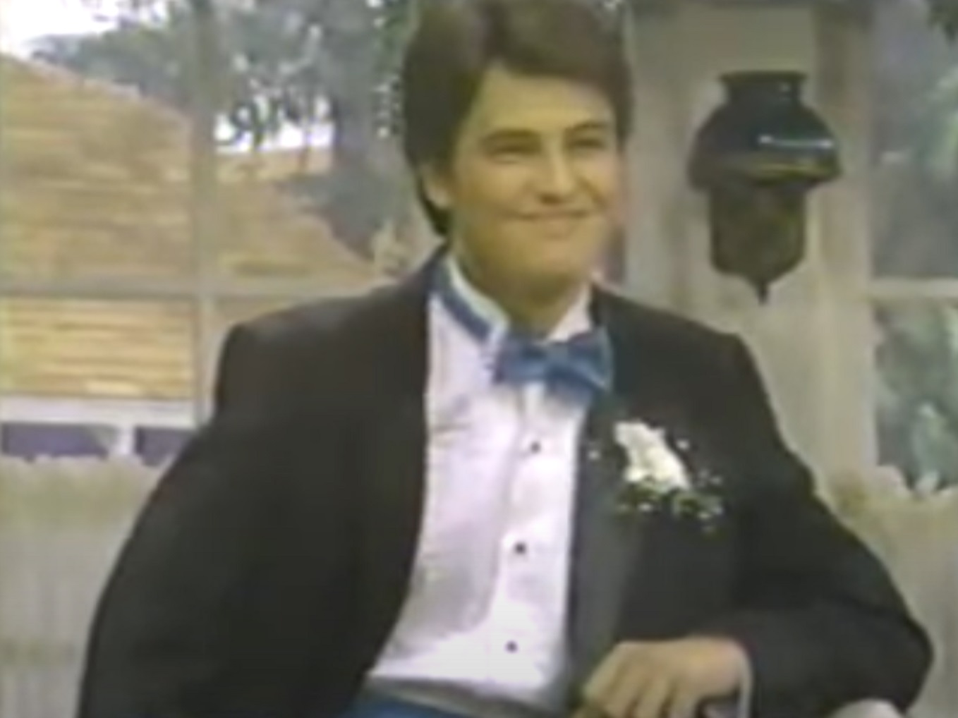 Screenshot: Matthew Perry wearing black suit and smiling - from Boys Will Be Boys (1987-88)
