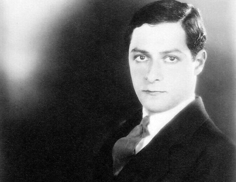 American actor, singer, songwriter and film producer George Jessel in black suite and tie