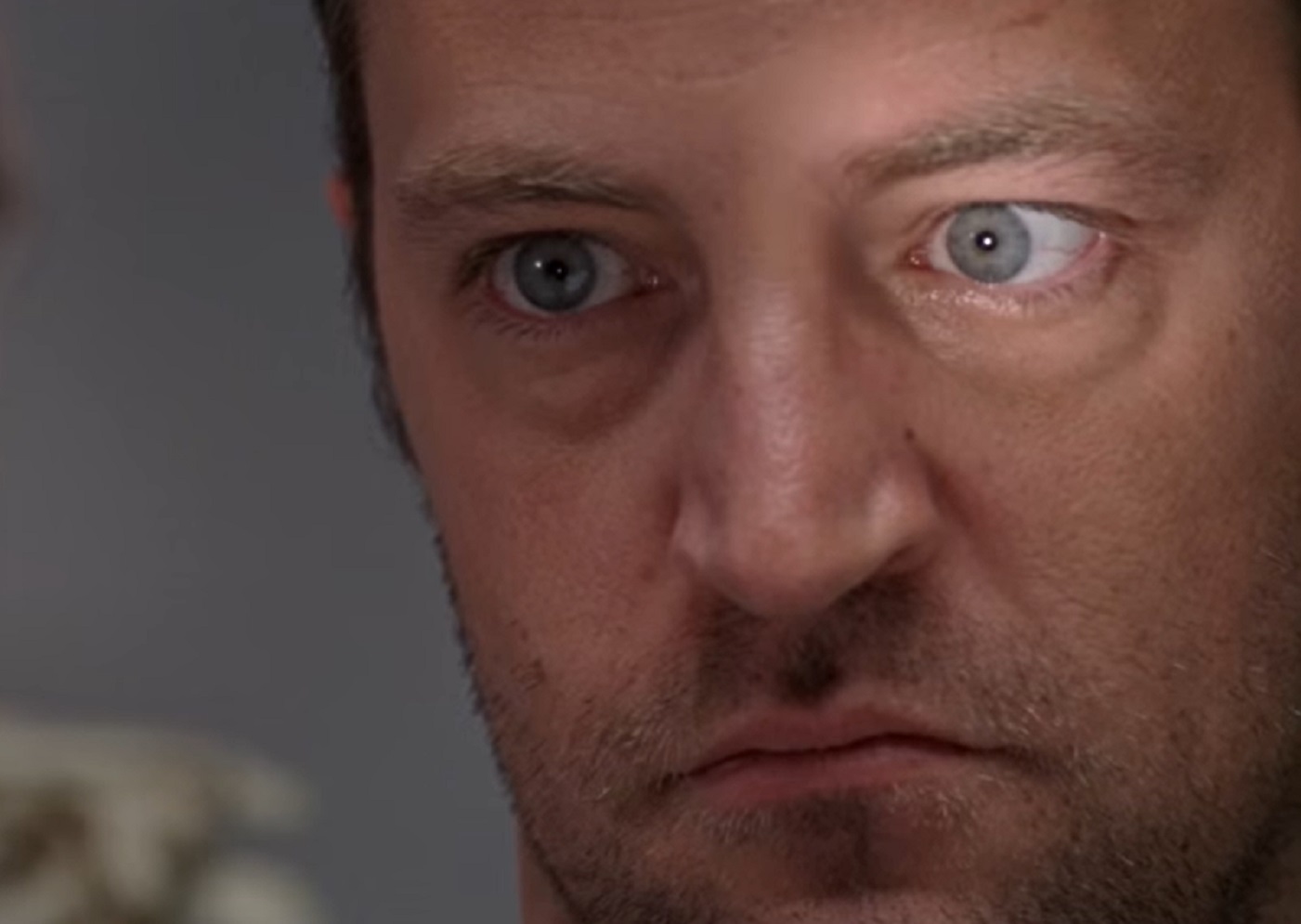 Screenshot: Close up photo of Matthew Perry looking at side serious - from  Numb (2007)