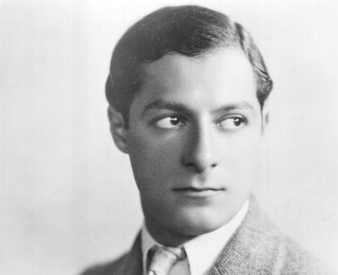 Photo of George Jessel in gray suit and tie