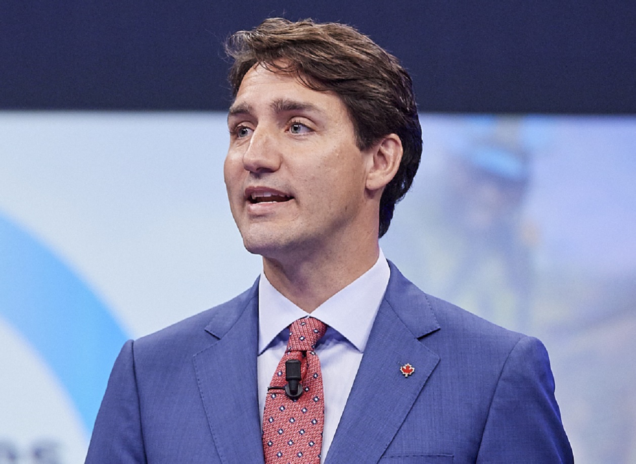 Justin Trudeau wearing blue suit with red tie ,looking at side - 2018