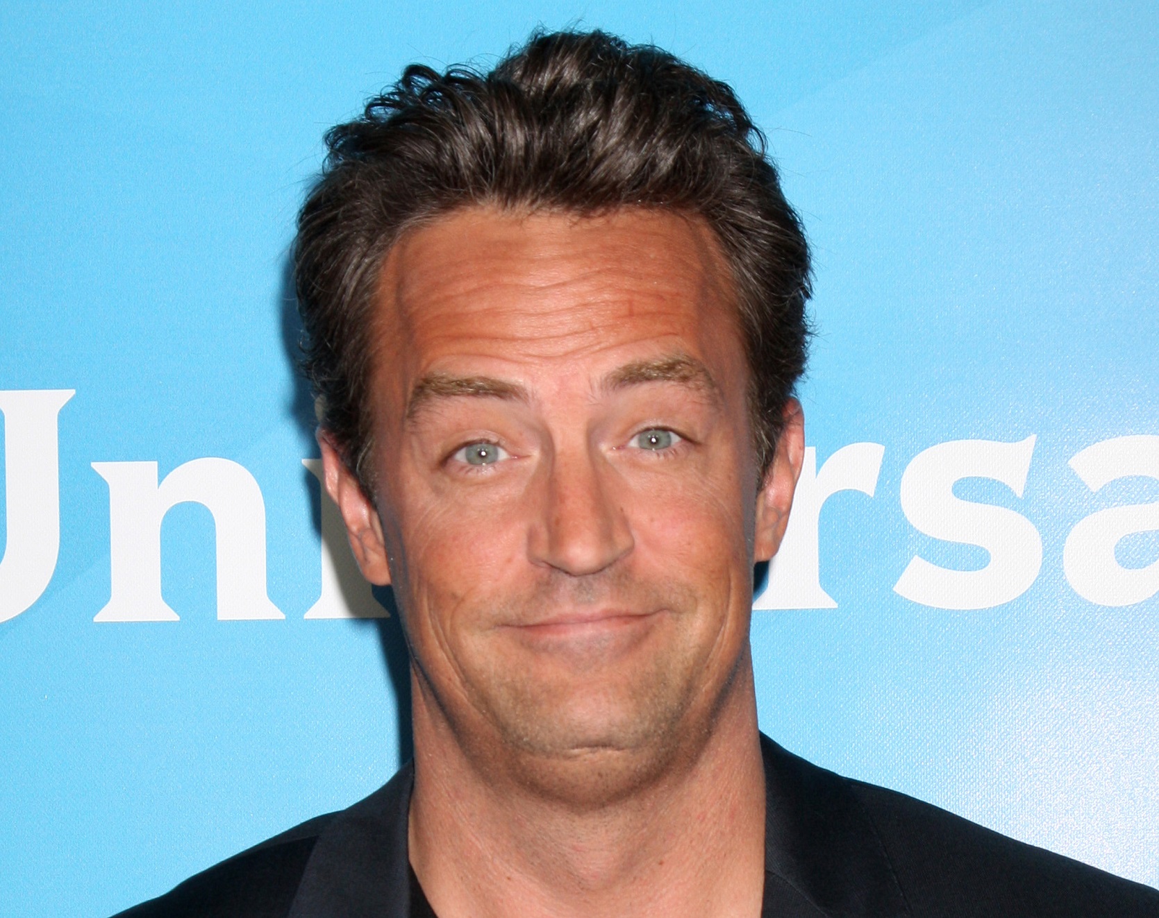 Matthew Perry looking at camera with surprised face - 2012