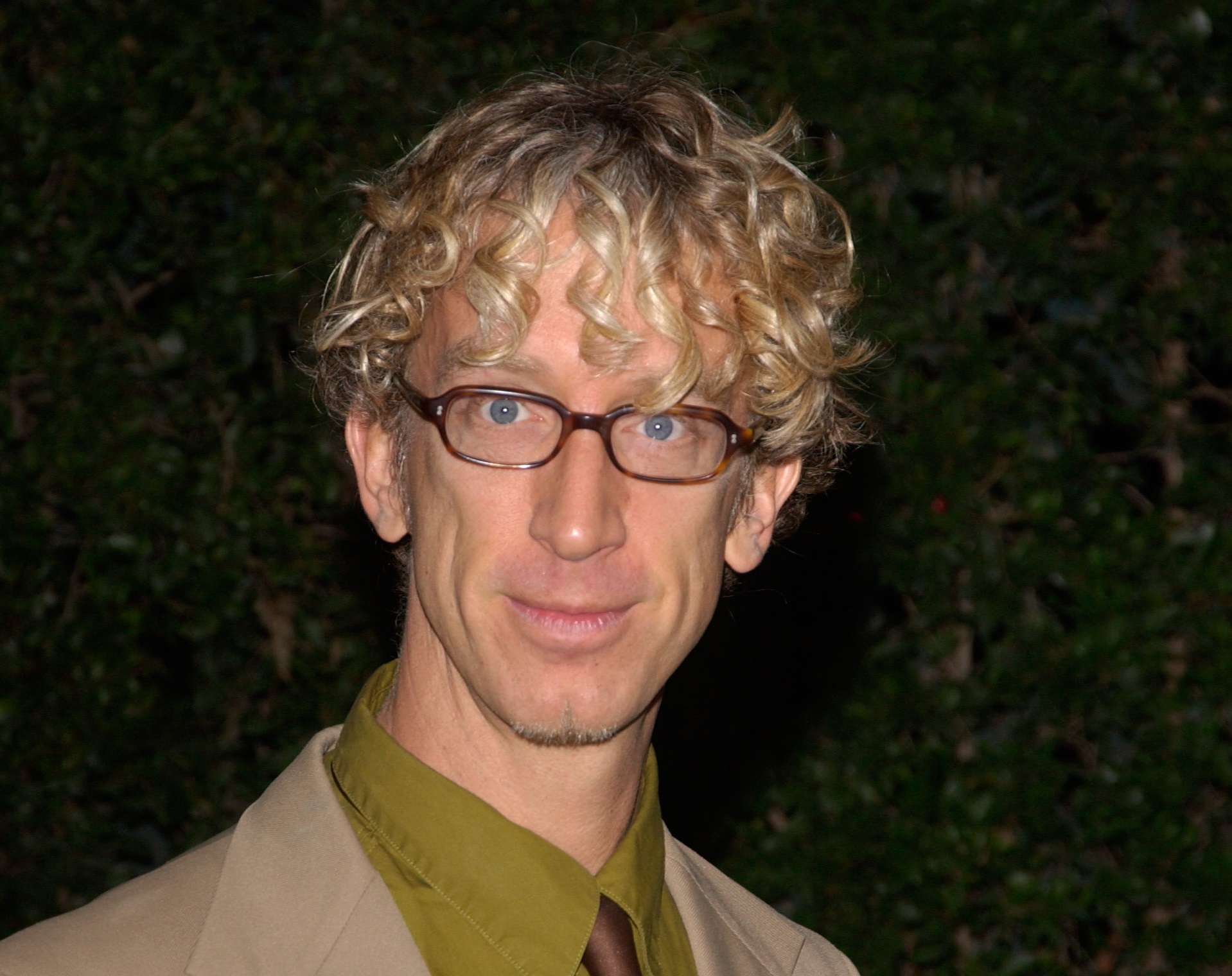 Actor ANDY DICK wearing green shirt and brown suit and tie looking at camera - 2004