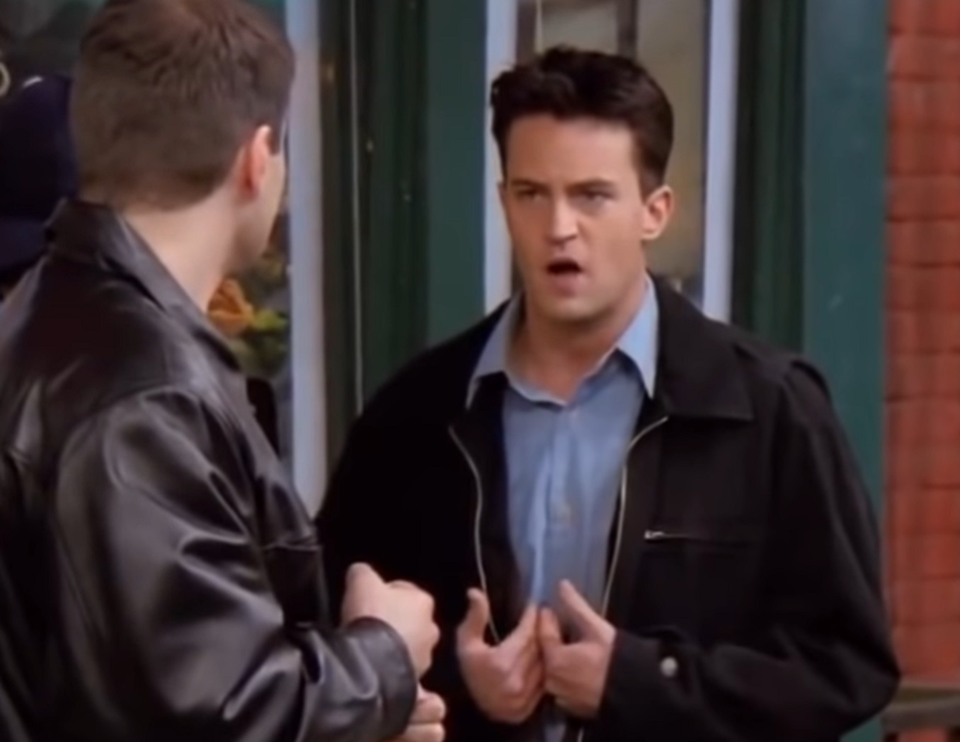 Screenshot: Matthew Perry looking upset and talking with other man - from Friends (1994-2004)