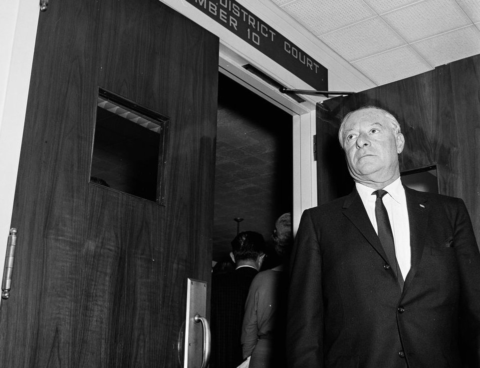 George Jessel getting out of court where he was a witness in a case,