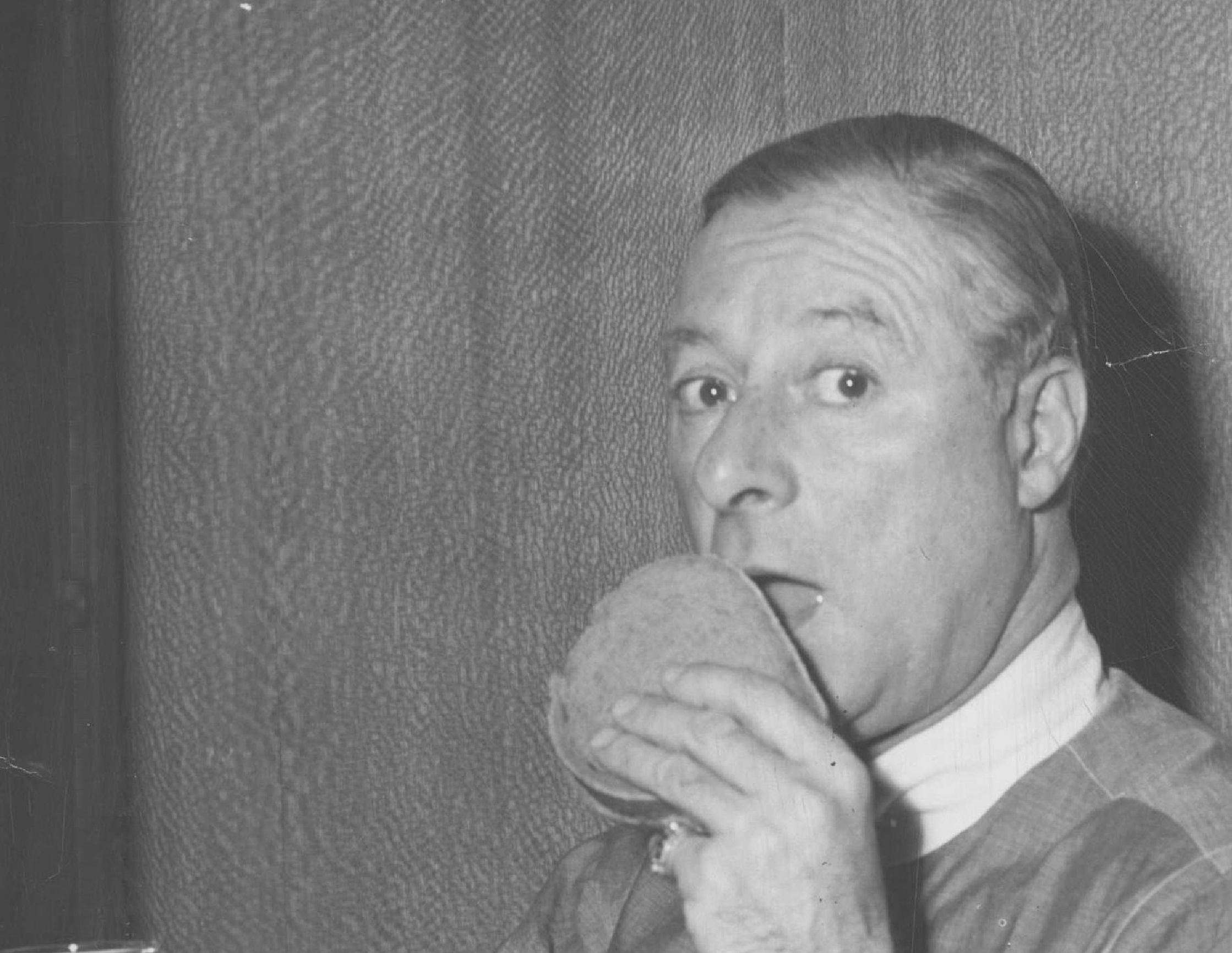 George Jessel eating a burger