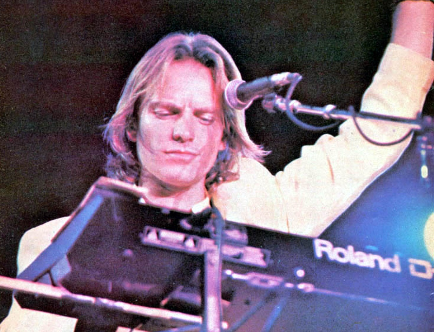 Sting with long hair is playing keyboards - 1987