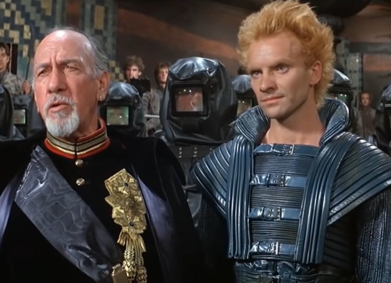 Screenshot: Sting wearing blue futuristic suit - from Dune (1984)