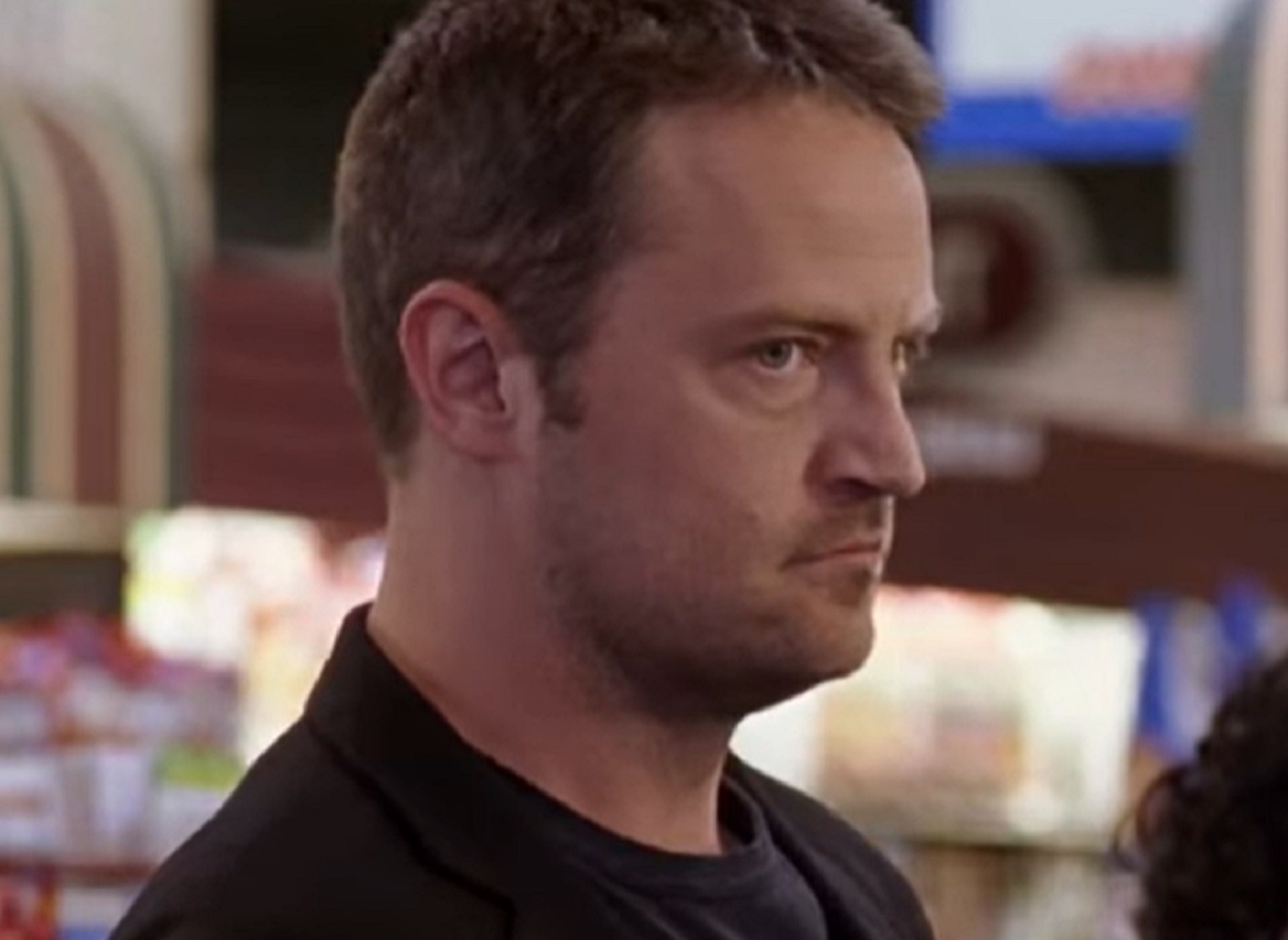 Screenshot: Matthew Perry wearing black shirt and looking angry - from Numb (2007)