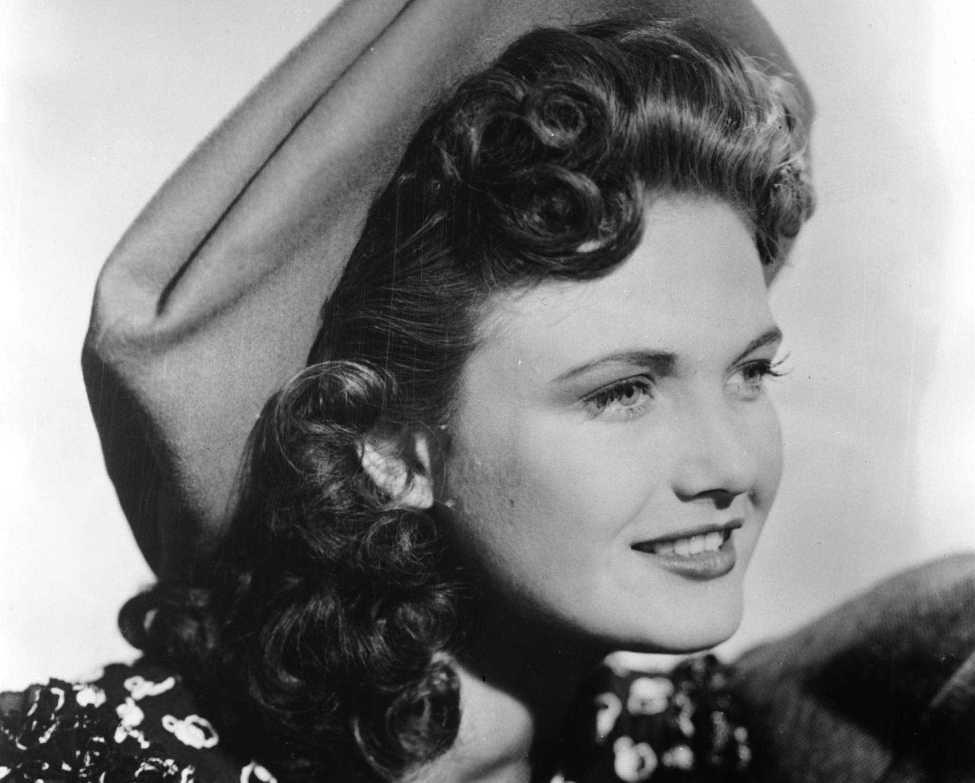 Lois Andrews, 1940s wearing a hat and patterned dress