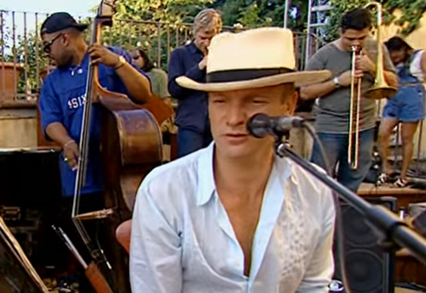 Screenshot: Sting is performing with band outside - from Sting-All This Time (2001)