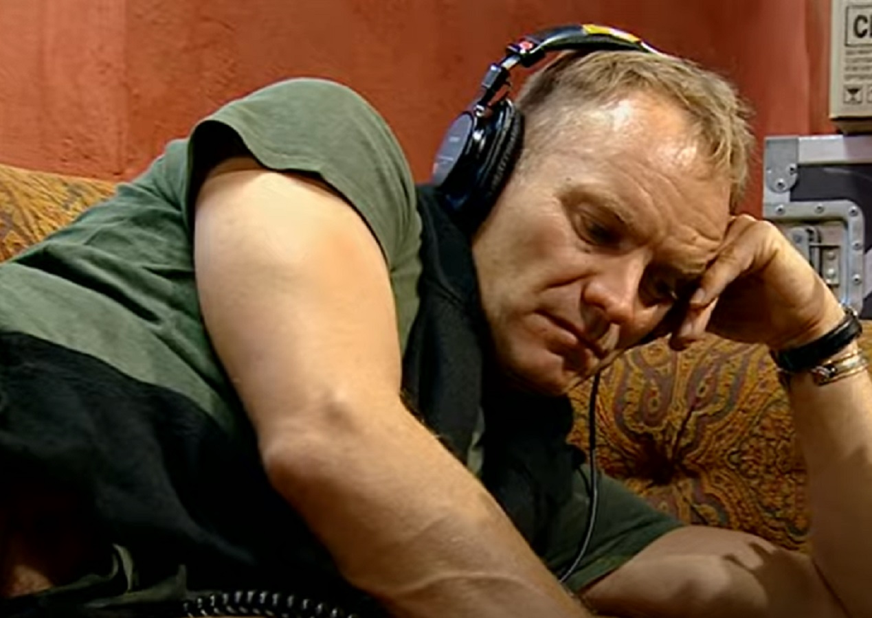 Screenshot: Sting wearing headphones and thinking - from Sting-All This Time (2001)