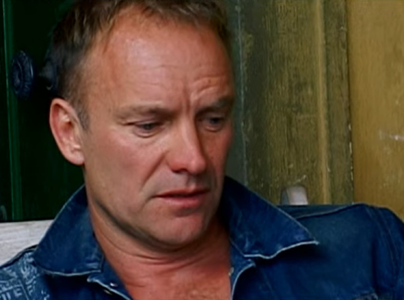 Screenshot: Sting looking down with sad face - from Sting-All This Time (2001)