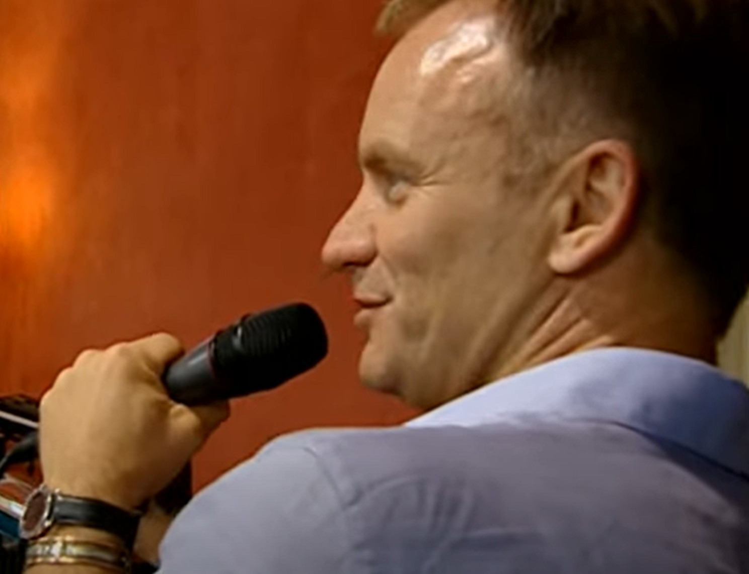 Screenshot: Sting is performing on microphone - from Sting-All This Time (2001)