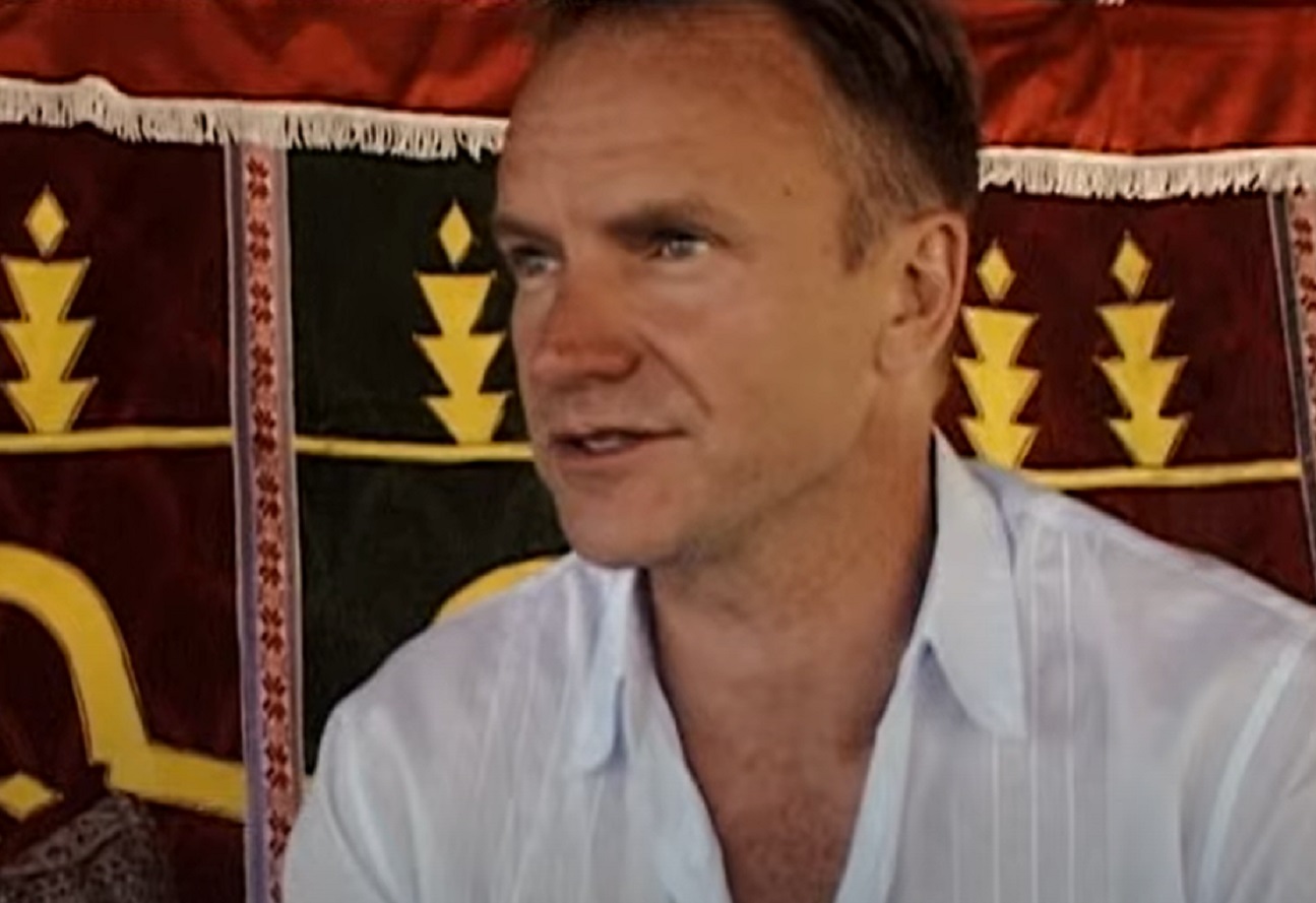 Screenshot: Sting is talking and looking at side - from Sting-All This Time (2001)