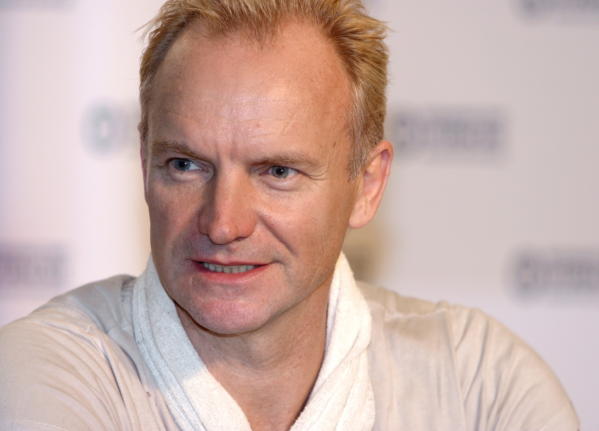 Sting wearing grey shirt is talking and looking at side - 2005