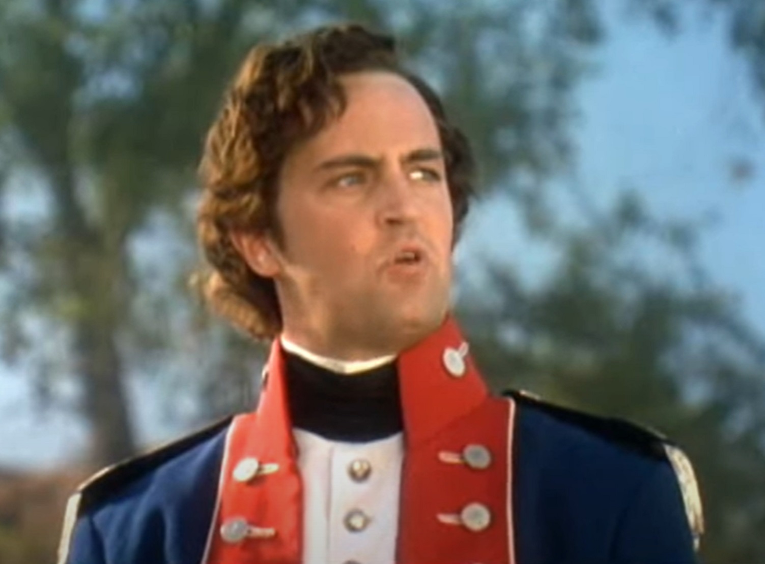 Screenshot: Matthew Perry in old military uniform, looking at side - from Almost Heroes (1998)