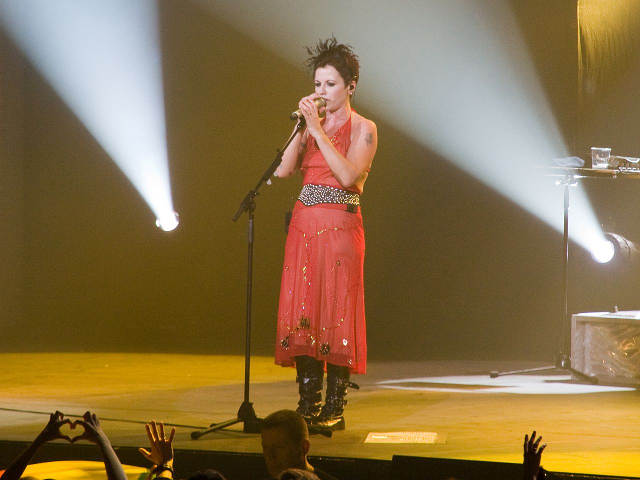 Dolores O'Riordan wearing red dress is performing live on stage - 2010