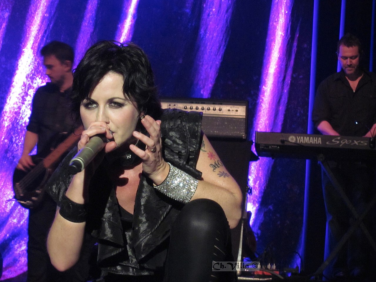 Dolores O'Riordan is performing live on stage,looking at people - 2012