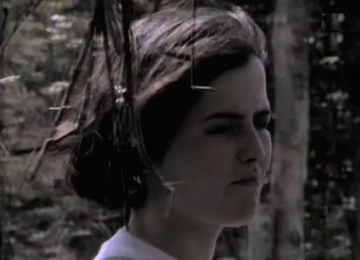 Screenshot: Dolores O'Riordan wearing white shirt is walking outside - from Dolores (TV documentary,2018)