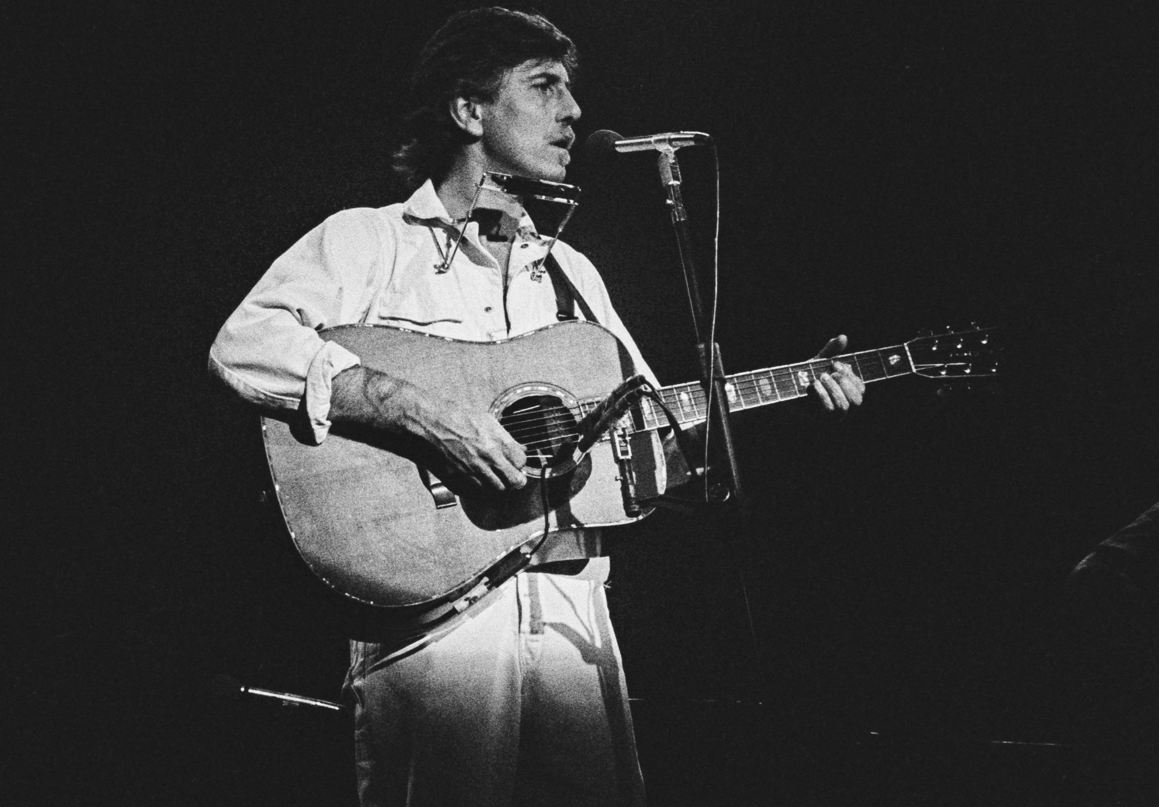 Graham Nash Atlanta 1980 performing on stage in white shirt