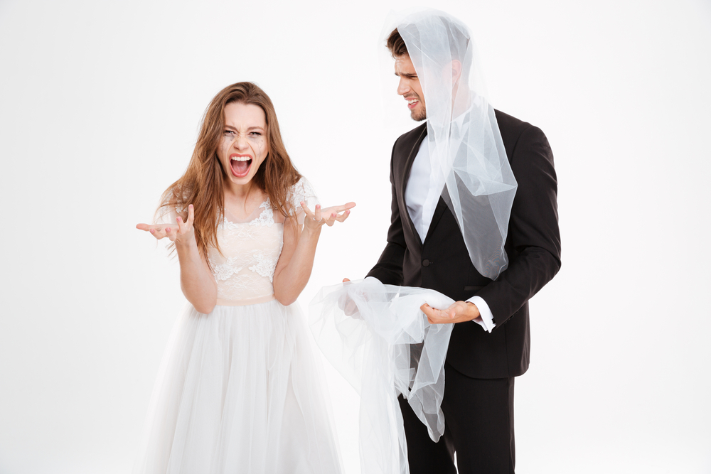 Quarrel of a married couple at their wedding day in wedding apparel