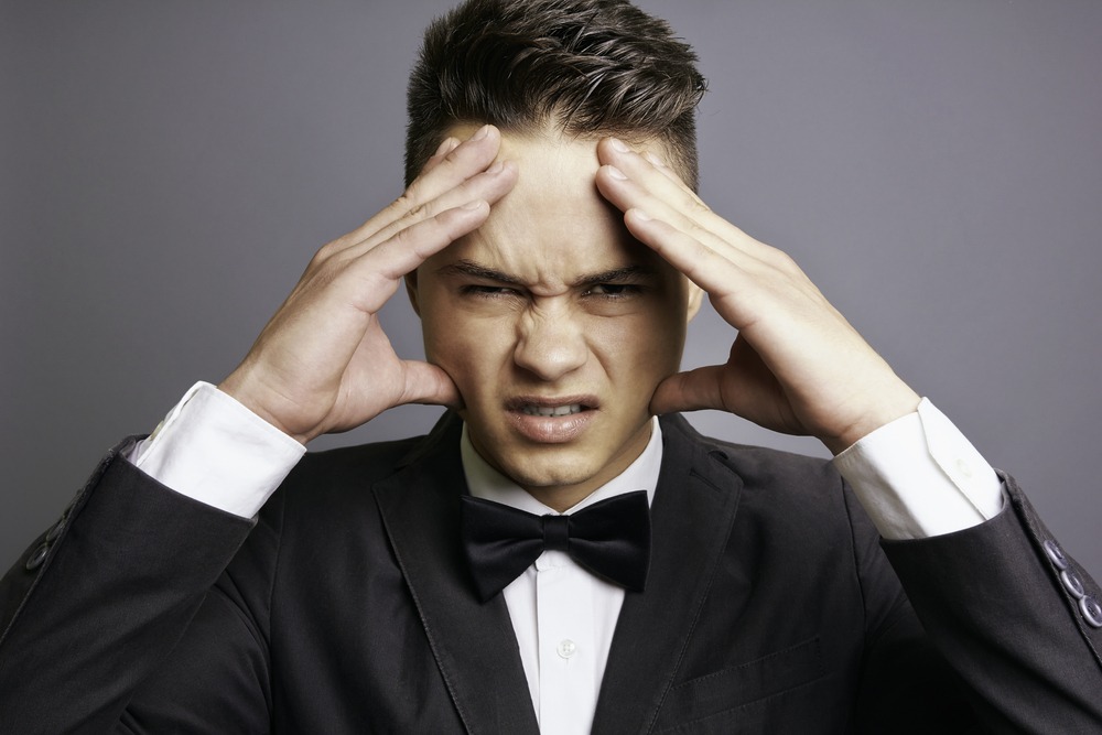 Angry groom holding his head