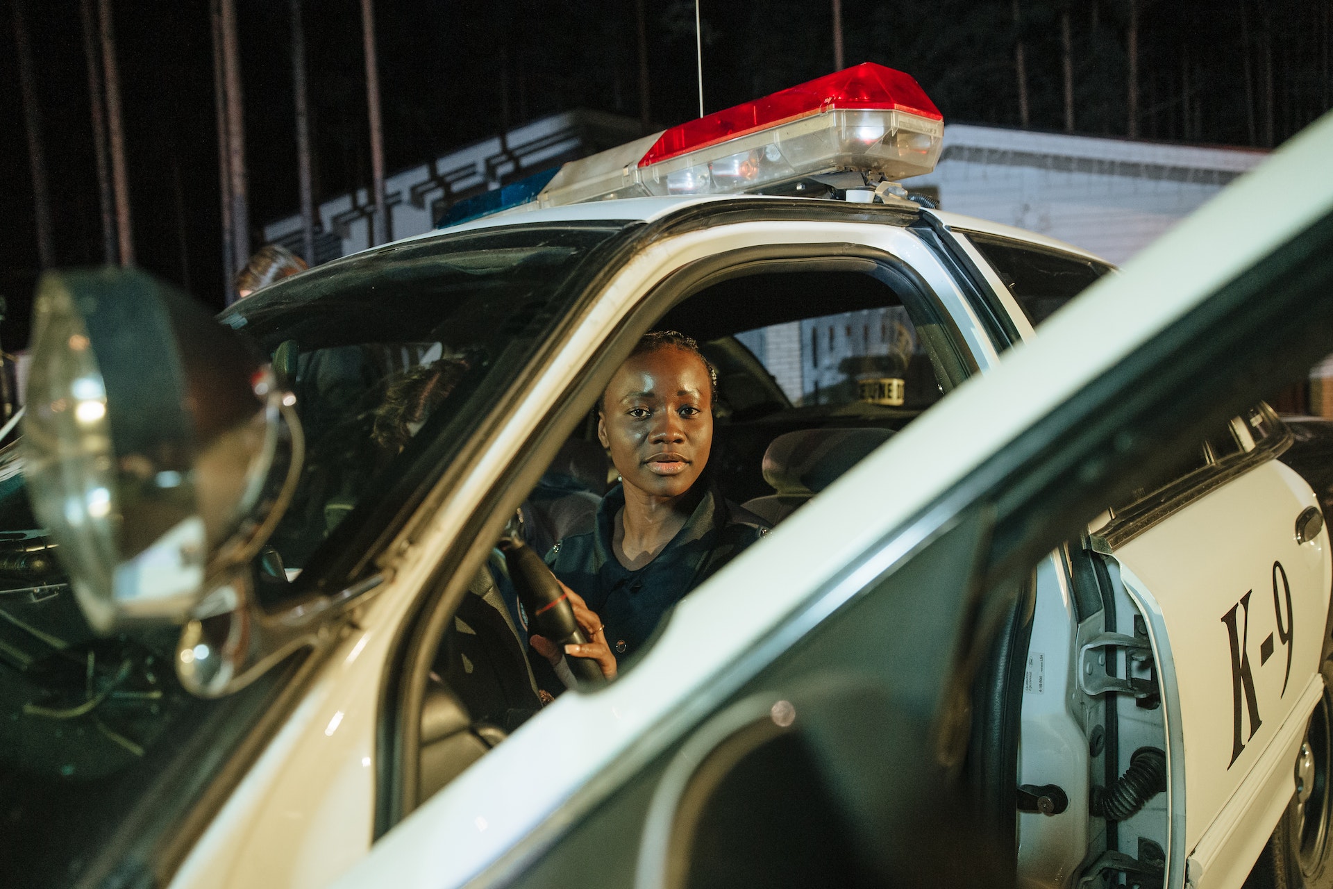 Woman police officer sitting in a police car