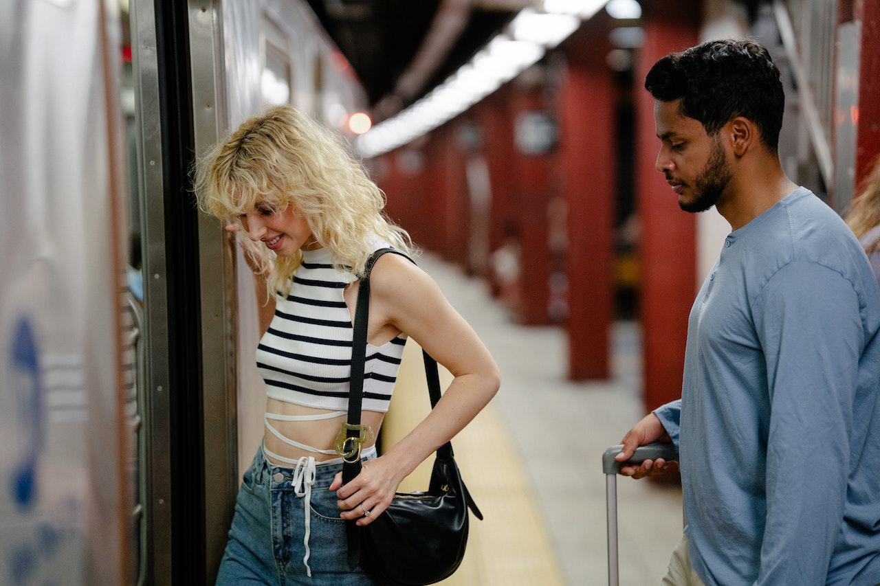 Man and woman boarding a subway train