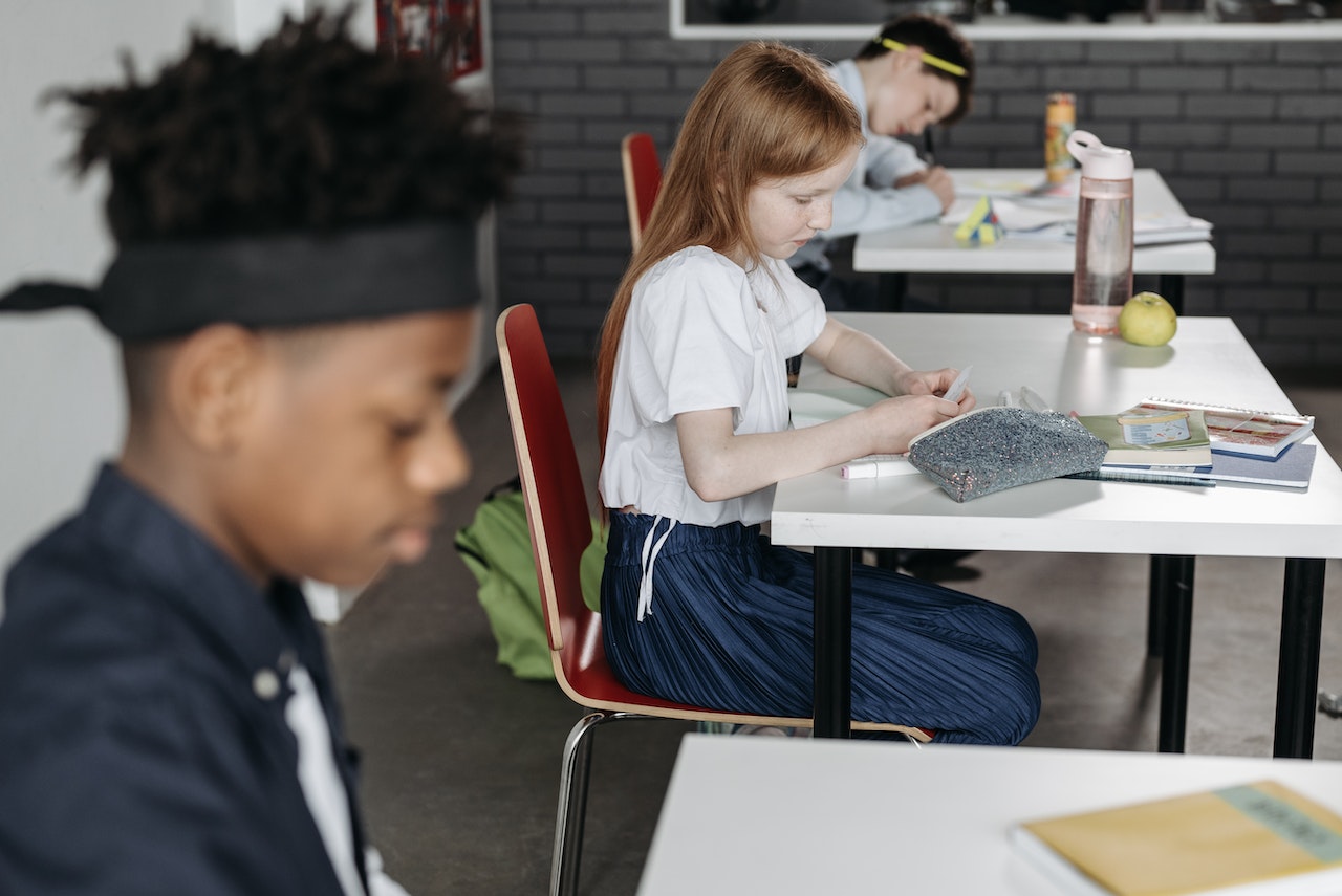 Children seating in classroom.