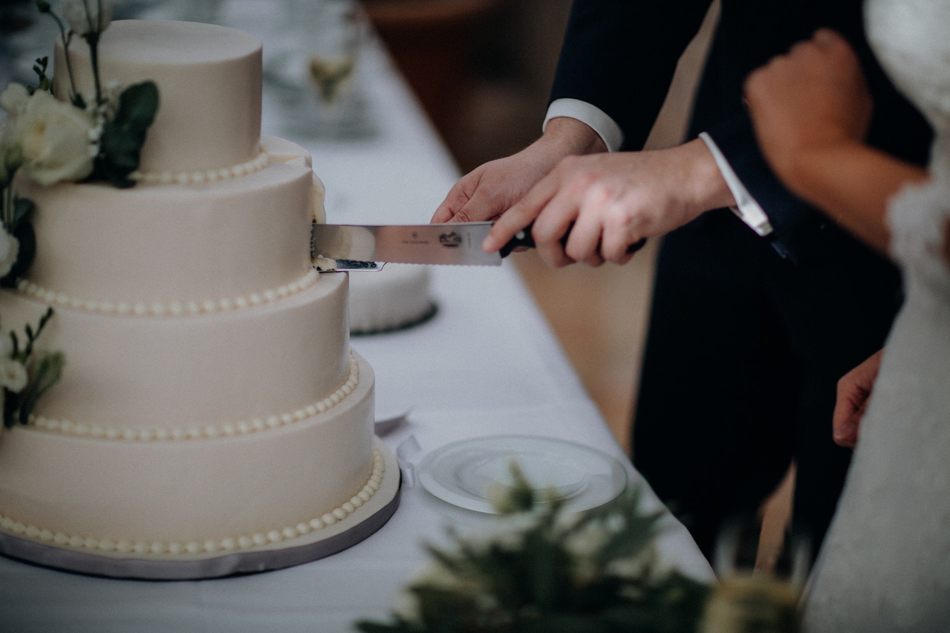 Bride and groom cutting wedding cake