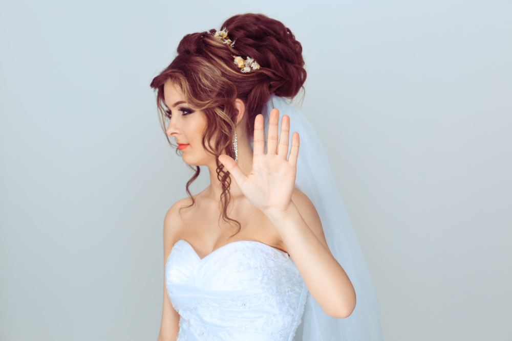 Angry bride showing  stop sign with hand looking away to the side
