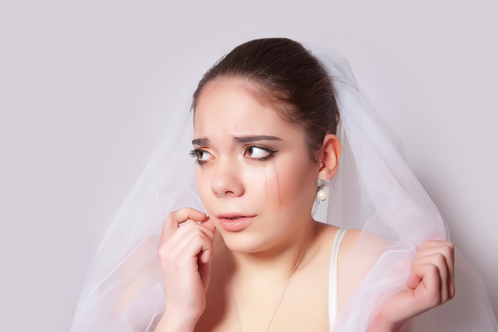 Portrait of a lonely beautiful bride crying