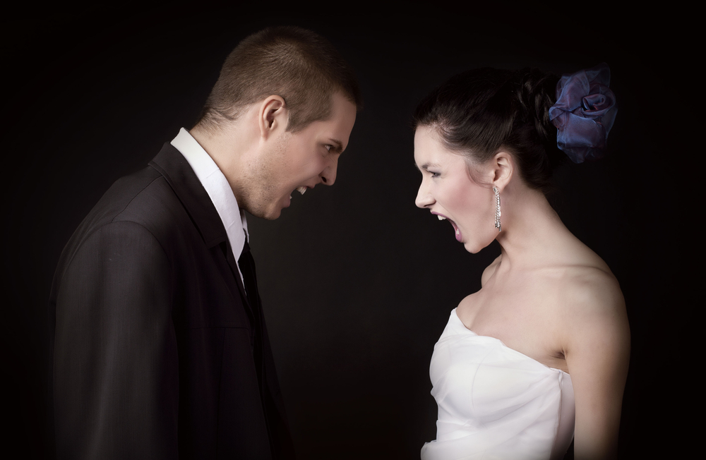 Just married young Caucasian couple arguing and shouting at each other