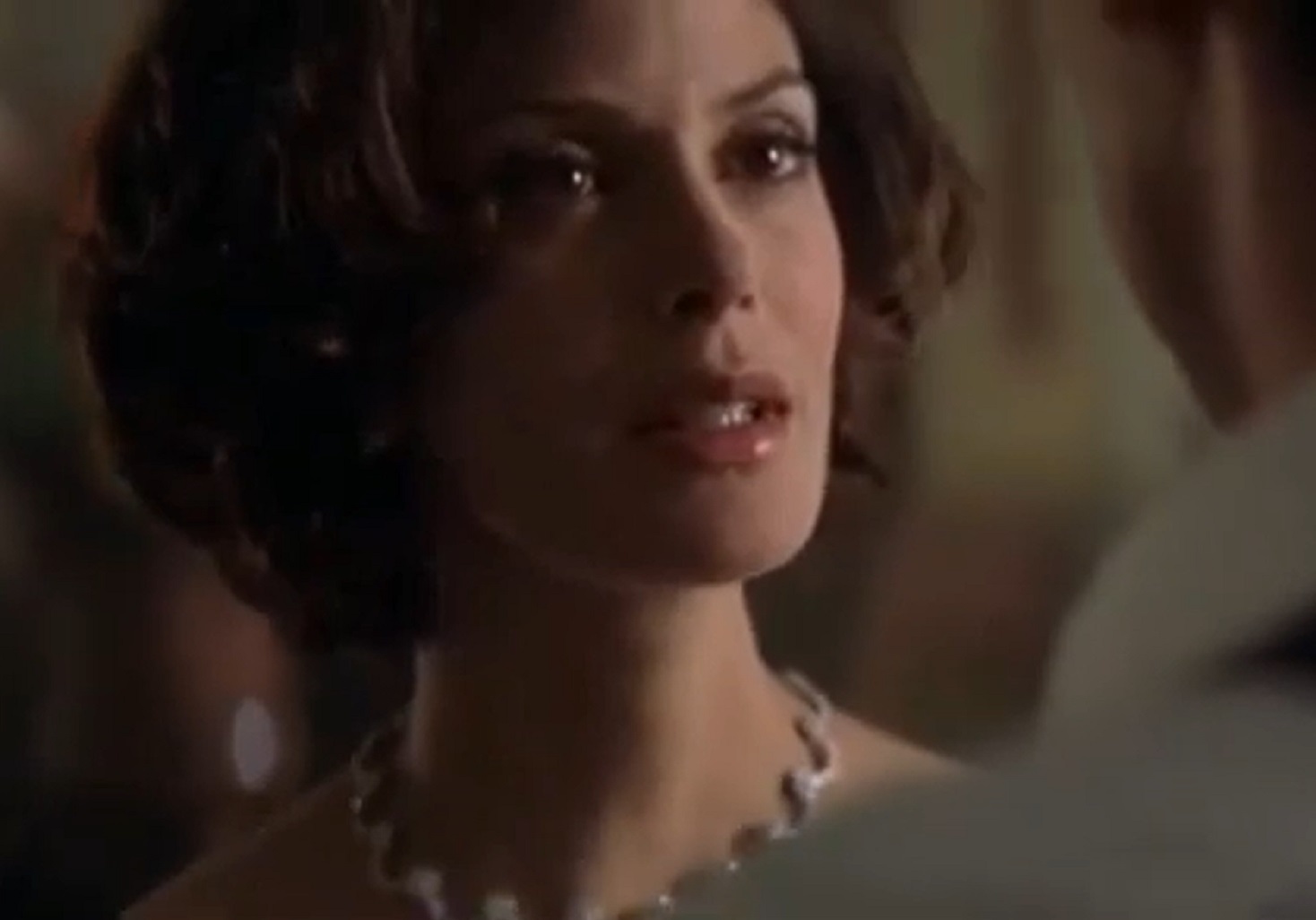 Screenshot: Teri Hatcher is looking at side with sad face - from Tomorrow Never Dies (1997)