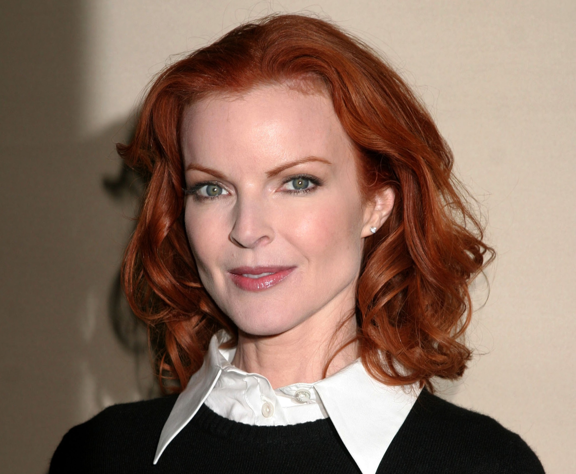 Marcia Cross wearing white shirt and black sweater is looking at camera and smiling - 2005