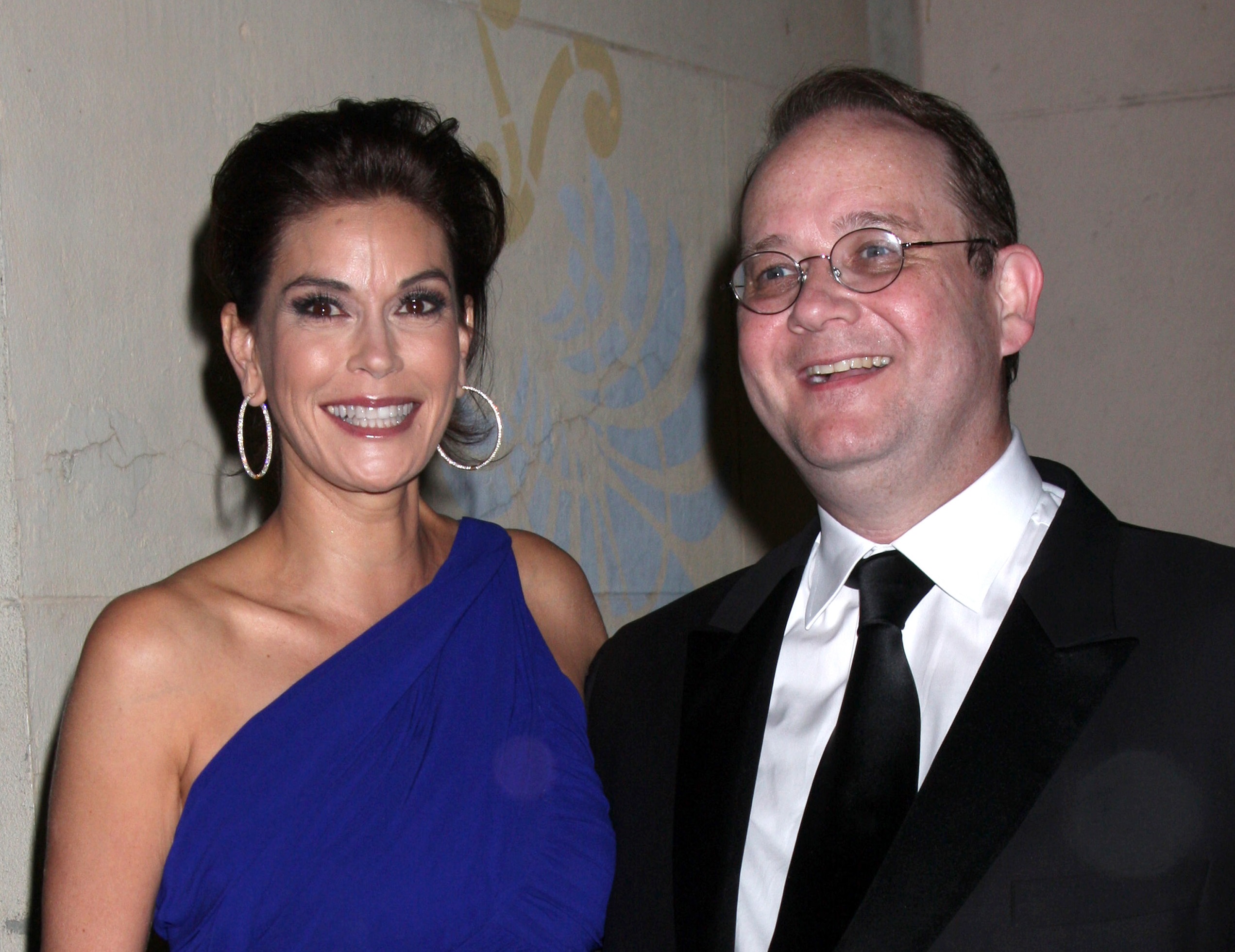 Teri Hatcher wearing blue dress and Marc Cherry wearing black suit ,looking at side and smiling - 2010
