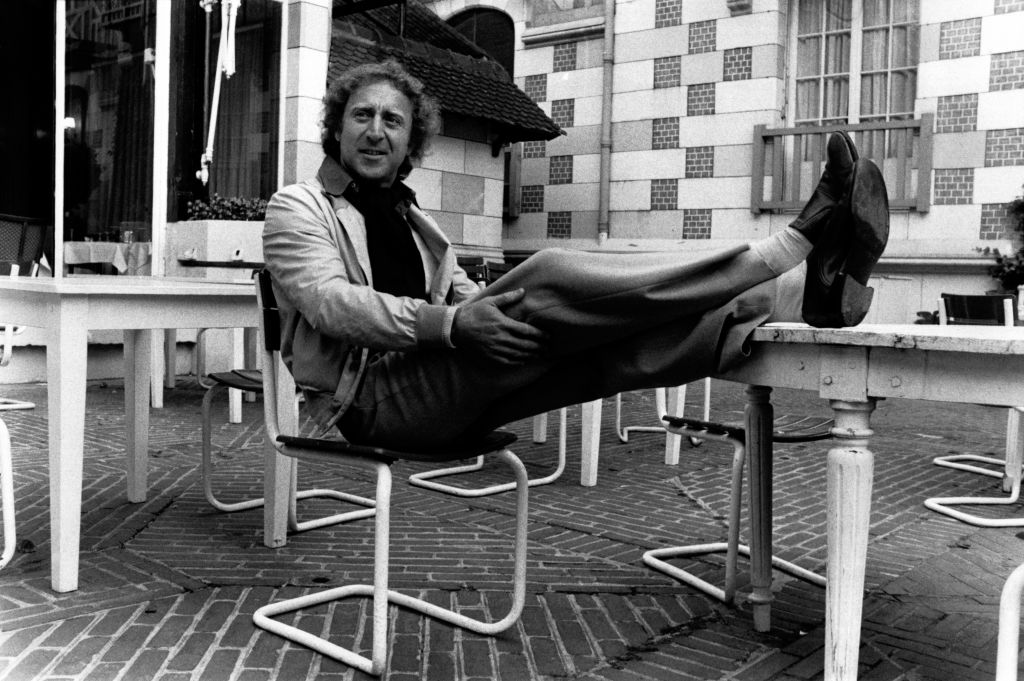 Gene Wilder sitting on a chair in jacket