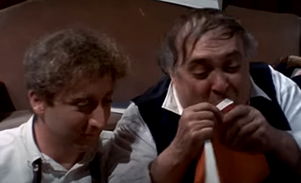 Gene Wilder in The Producers (1967) in white shirt looking at right