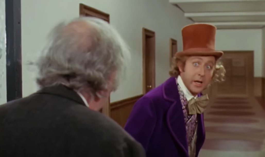 Gene Wilder as  Willy Wonka in purple suit and a hat