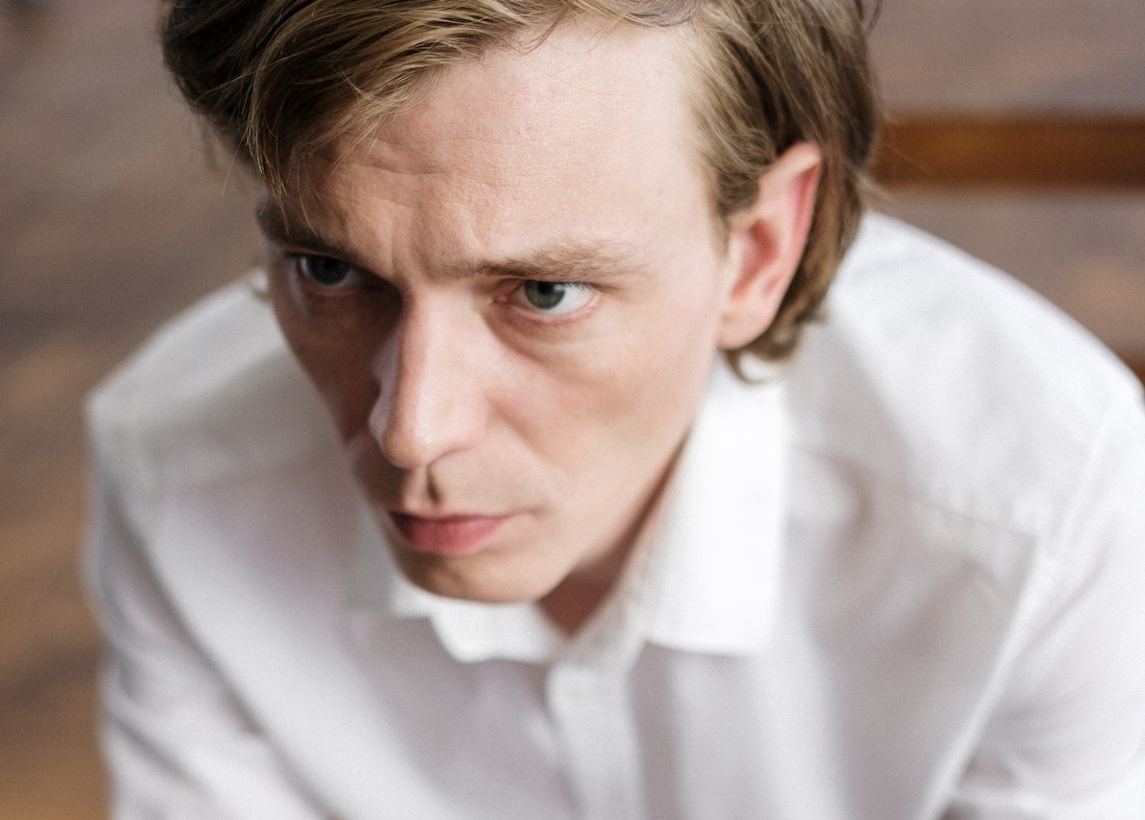 Man wearing white shirt is thinking.